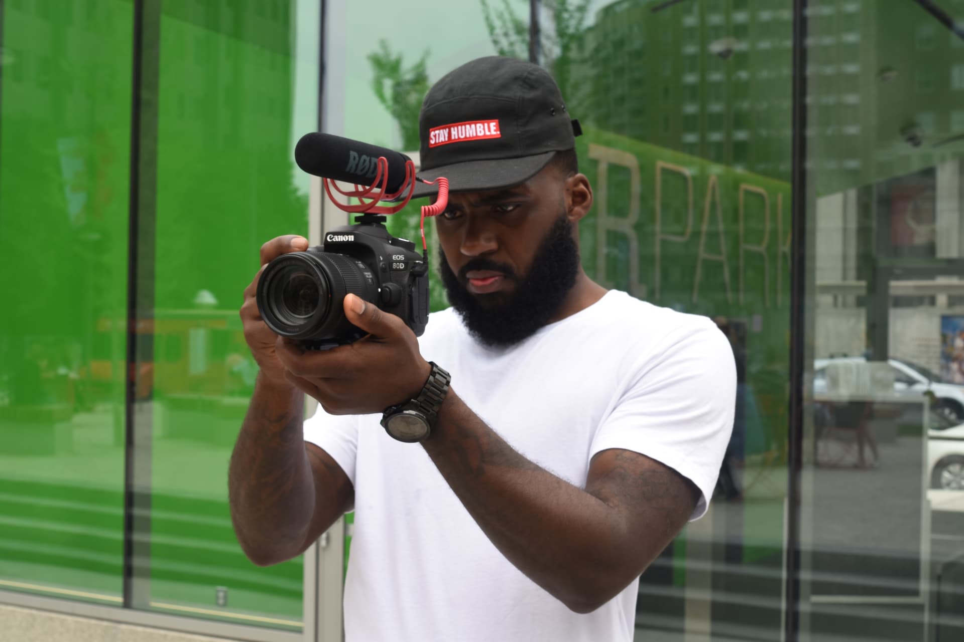 André Davis filming with a handheld camera on location.